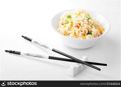 bowl with rice and chopsticks