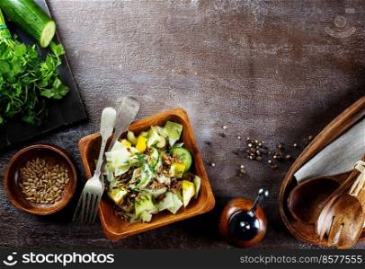 Bowl with tasty vegetable salad on stone table