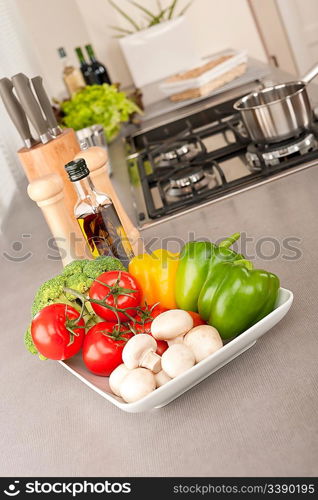 Bowl with vegetable in modern kitchen, focus on pepper
