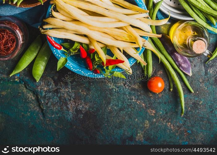 Bowl with White beans pods on rustic background, top view