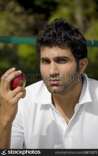Bowler checking the cricket ball