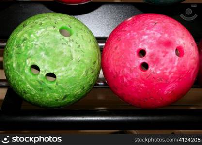 Bowling balls red green closeup row detail