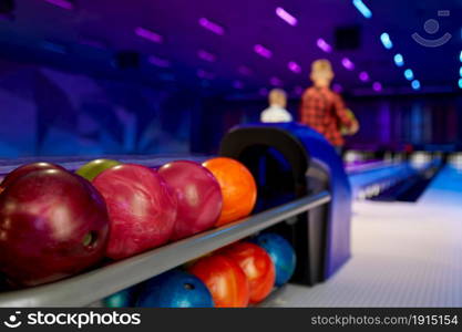 Bowling balls, two boys at the lane on background. Kid preparing to score a strike. Children having fun in entertainment center, little bowler. Bowling balls, two boys at the lane on background