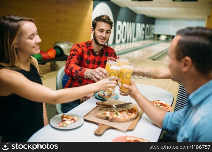 Bowling team celebrate the victory in the competition. Friends relax after playing tenpin game in club, active leisure, healthy lifestyle. Bowling team celebrate victory in the competition