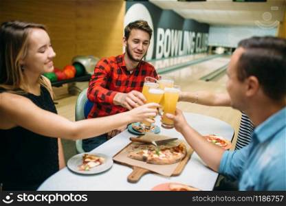 Bowling team celebrate the victory in the competition. Friends relax after playing tenpin game in club, active leisure, healthy lifestyle. Bowling team celebrate victory in the competition