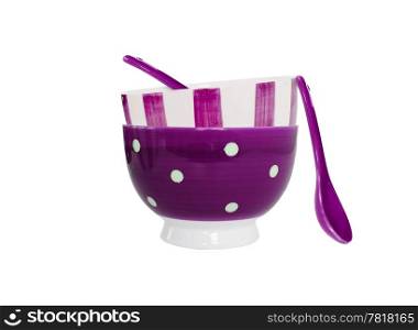 Bowls in different purple patterns and two spoons on white background