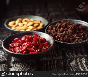 Bowls of dried fruit and nuts, close-up