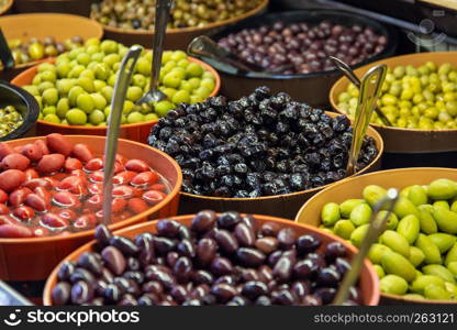 Bowls of green and black olives on display on a stall in St Lawrence Market, Toronto, Canada