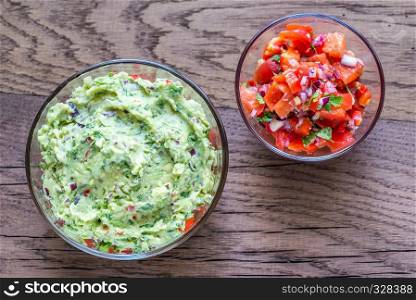 Bowls of guacamole and salsa