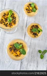 Bowls of passion fruit mousse garnished with passion fruit fruit
