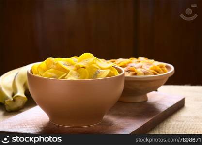Bowls of salty (front) and sweet (back) plantain chips, a popular snack in South America photographed with natural light (Selective Focus, Focus on the upper chips)