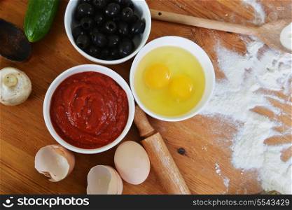 bowls with eggs, ketchup and olives on the kitchen table