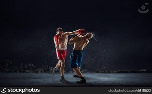 Box fighters trainning outdoor. Two strong fighters outdoor demonstrating ultimate fighting