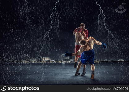 Box fighters trainning outdoor. Two strong fighters outdoor demonstrating ultimate fighting