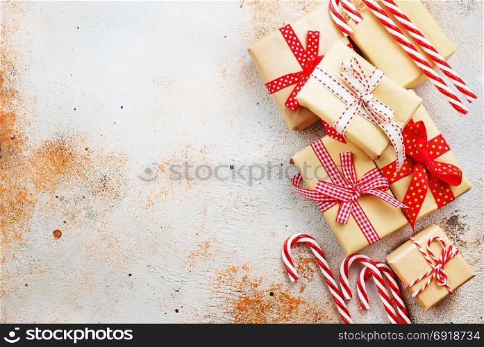 box for present and candy cane on a table