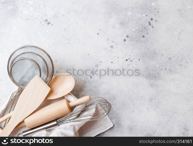 Box of baking utensils. Whisk, mesh and spatula in vintage wooden box.Top view.