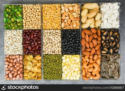 Box of different whole grains beans and legumes seeds lentils and nuts colorful snack texture background / Collage various beans mix peas agriculture of natural healthy food for cooking ingredients