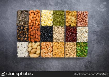 Box of different whole grains beans and legumes seeds lentils and nuts colorful snack background top view / Collage various beans mix peas agriculture of natural healthy food for cooking ingredients