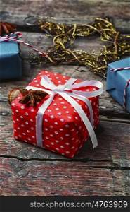Box with Christmas gifts. Three boxes with Christmas gifts on retro wooden background