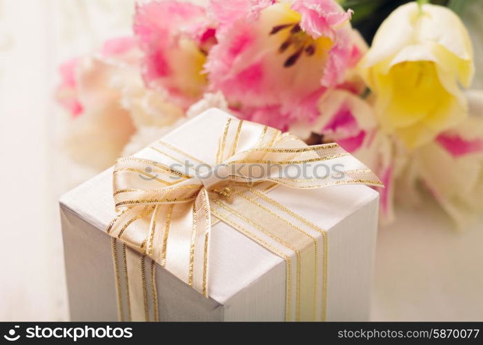 Box with present and tulips for mom