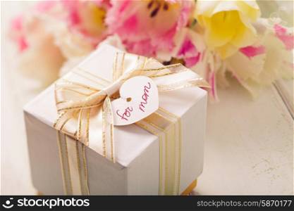 Box with present and tulips for mom