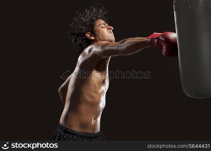 Boxer hitting punching bag aggressively