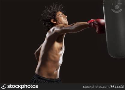 Boxer hitting punching bag aggressively