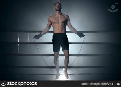 Boxer jumping rope in boxing ring. High quality photo. Boxer jumping rope in boxing ring.