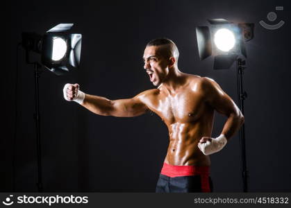 Boxer with studio lights in sports concept