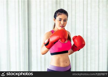 Boxer woman does boxing sport in fitness gym. Healthy lifestyle.