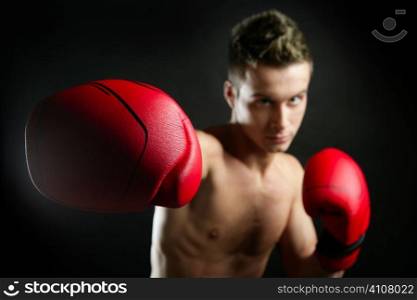 Boxer, young age handsome man over black background