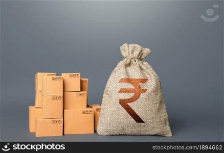Boxes and indian rupee money bag. The concept of trade in goods and production. Profit from trading. GDP economy. Import export. Warehousing logistics. Business industry. Delivering.