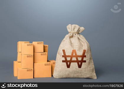 Boxes and south korean won money bag. The concept of trade in goods and production. Profit from trading. GDP economy. Import export. Warehousing logistics. Business industry. Delivering.