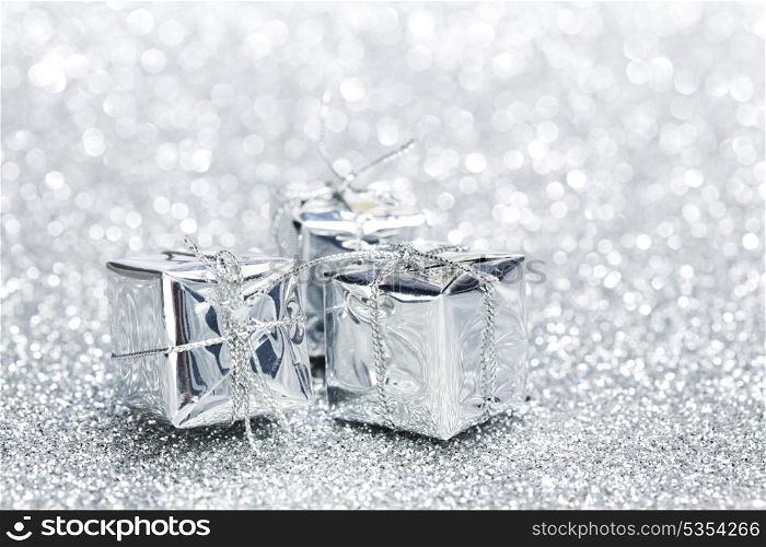 Boxes with christmas gifts on shiny silver background