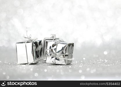 Boxes with christmas gifts on shiny silver background