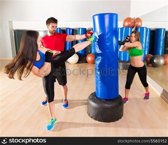 Boxing aerobox women group with personal trainer man at fitness gym