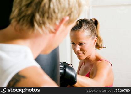 Boxing couple (male / female), trainer supervising the boxing student
