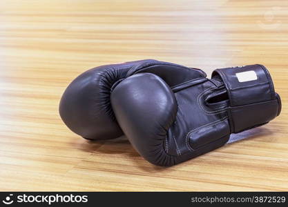 Boxing gloves black color on wooden floor