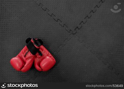 boxing gloves hang on nail on texture wall with copy space for text. Retirement concept
