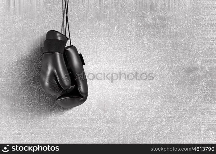 Boxing gloves hanging on nail on wall. Boxing gloves