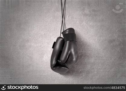 Boxing gloves hanging on nail on wall. Boxing gloves