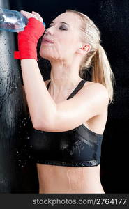 Boxing training woman pour water on face hold punching bag