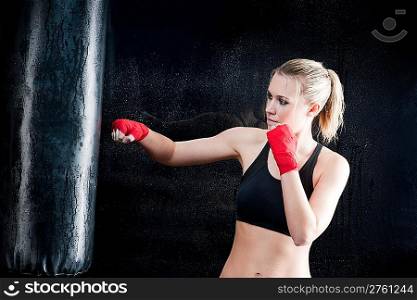 Boxing training woman sparring punching bag in gym wear gloves