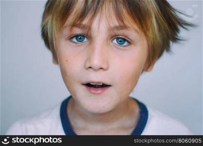 Boy 9 years old in front of a light background, close-up