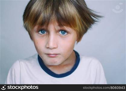 Boy 9 years old in front of a light background, close-up