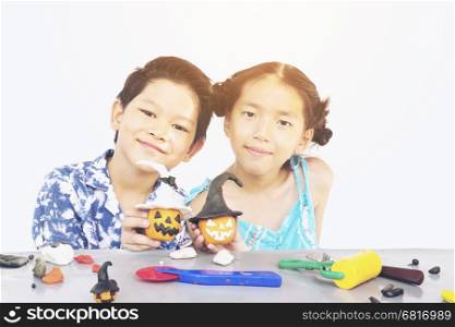 Boy and girl are happily playing clay toy