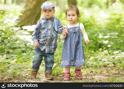 Boy and girl are playing in the park. Boy and girl