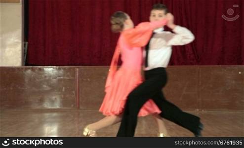 boy and girl dancing the waltz in the ballroom. DOF