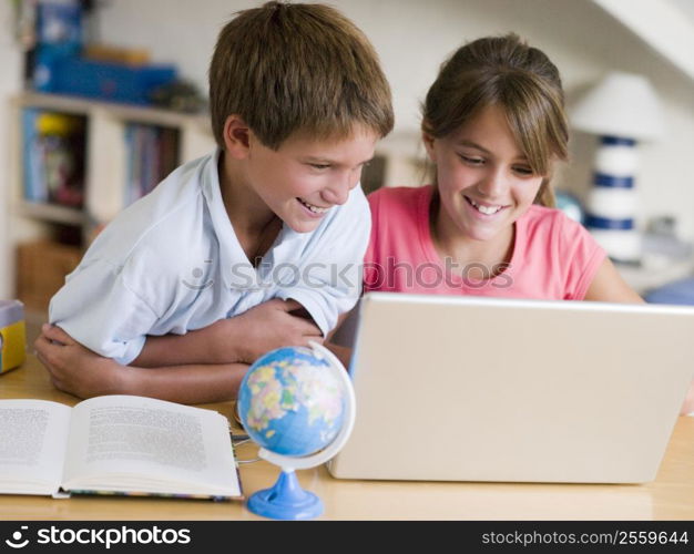 Boy And Girl Doing Their Homework On A Laptop