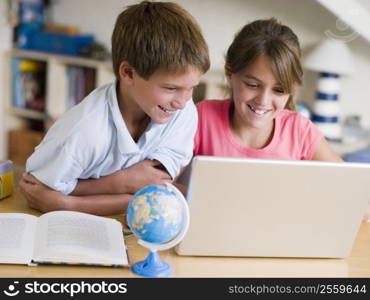 Boy And Girl Doing Their Homework On A Laptop